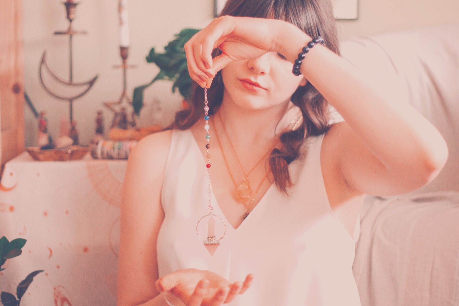 Woman telling fortune with silver pendant